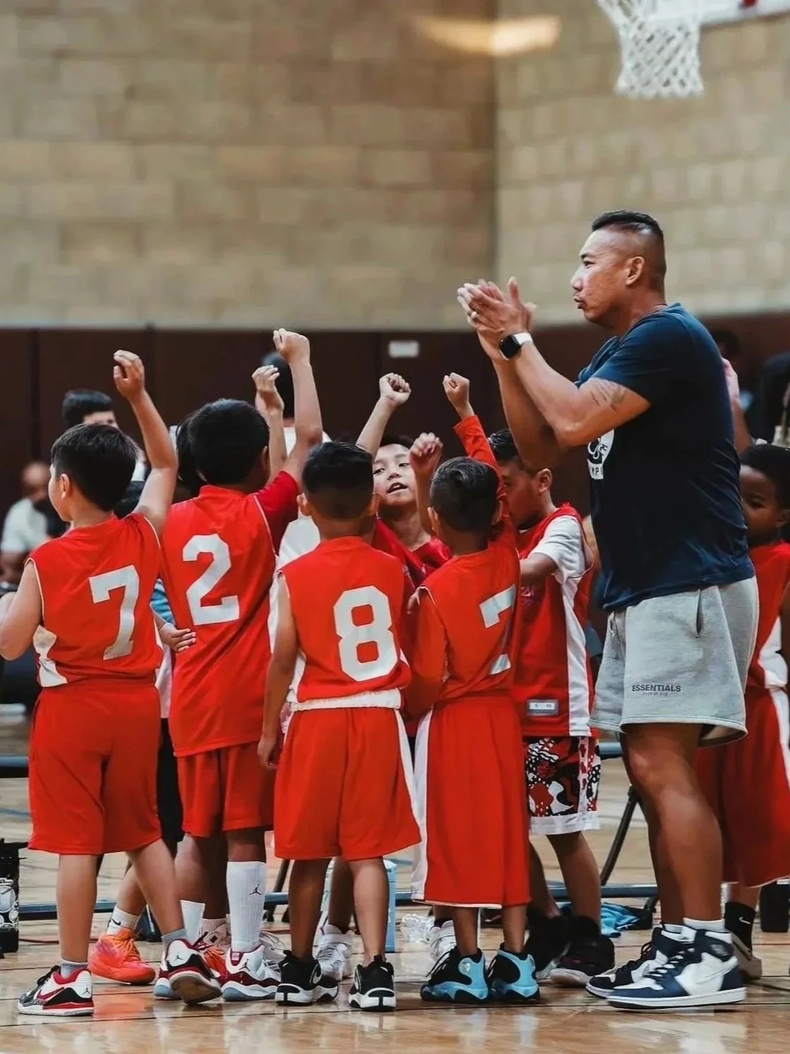 JC encouraging his youth basketball team during a huddle