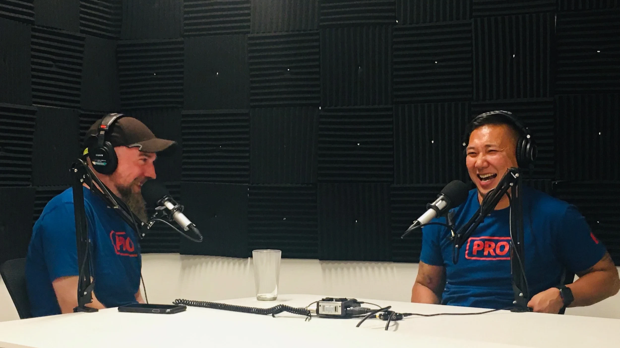 JC sharing a laugh during a podcast conversation
